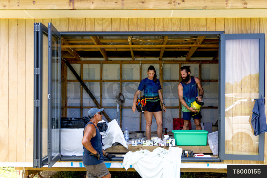 Electricians and builder on construction site