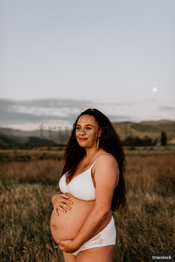 Woman Showing her Stomach in Maternity Shoot