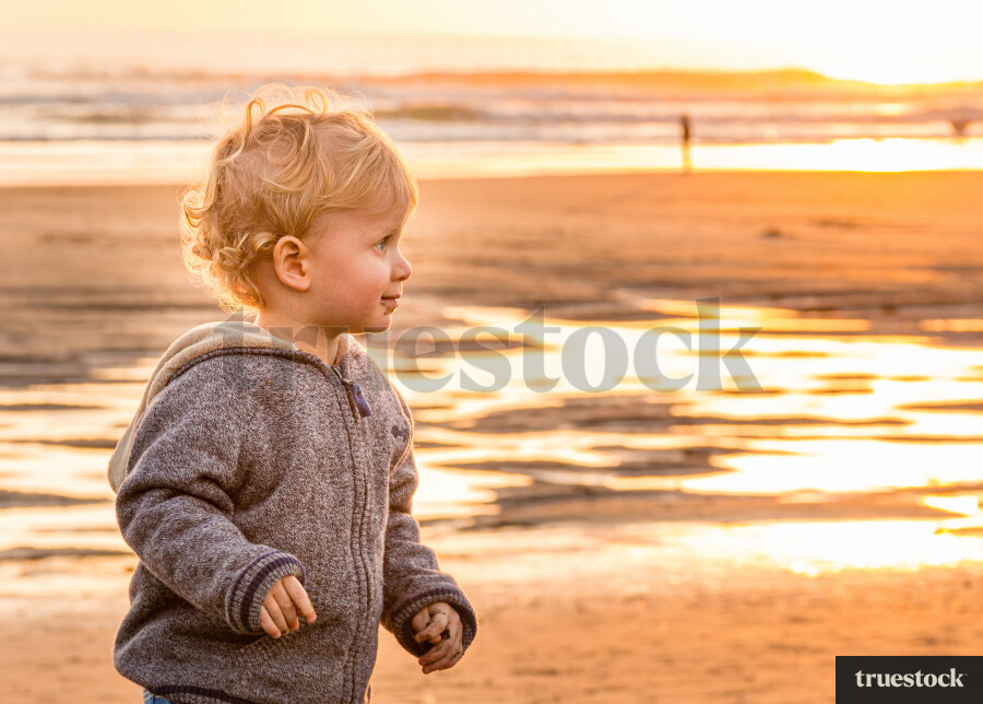 Toddler at the beach during sunset