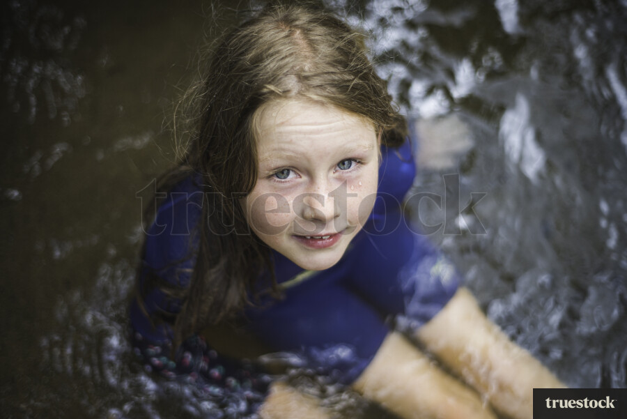 Young Girl Sitting in Water
