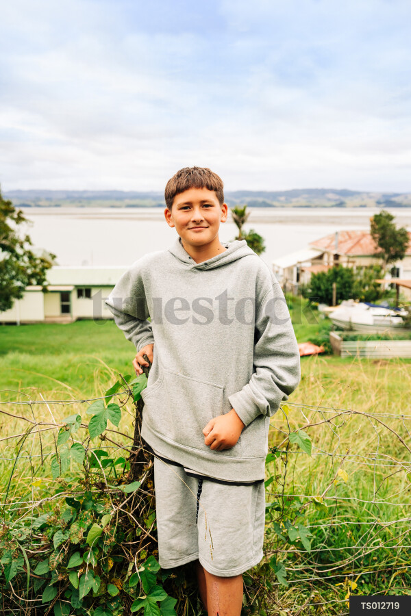 Boy in hoodie by beach