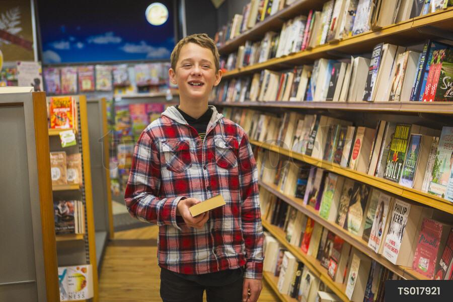 Smiling boy in bookstore