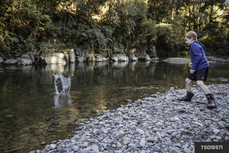 Kid Throwing Rocks into River