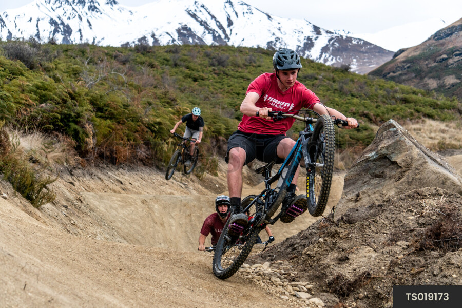 Men mountain biking on dirt trail