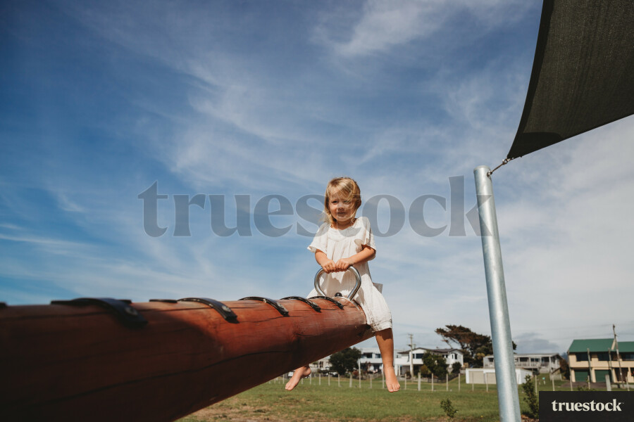 Child Playing on Seesaw at Waihi Beach