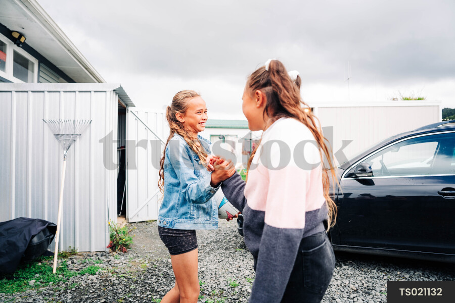 Girls playing by car