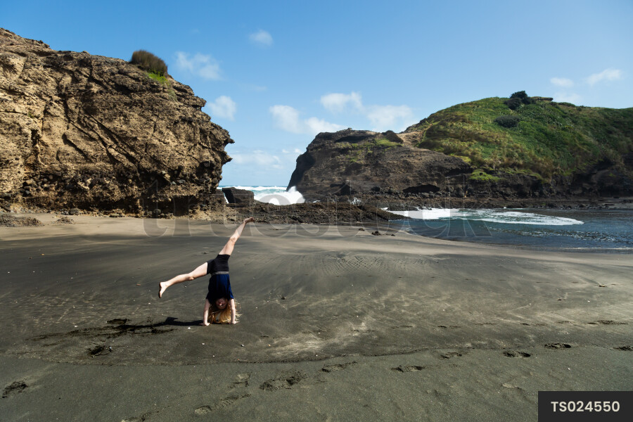 Girl playing at Piha Beach