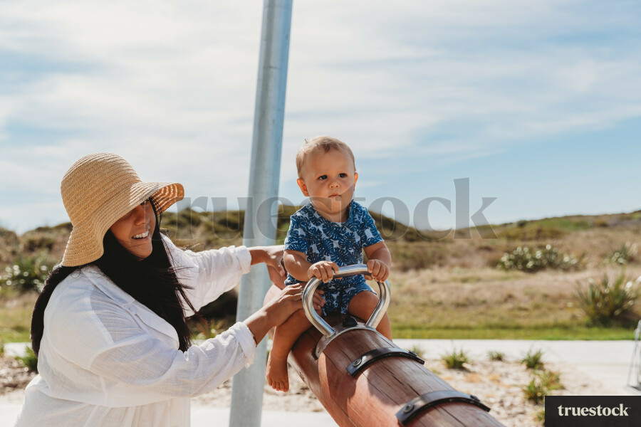 Child Playing on Seesaw at Waihi Beach