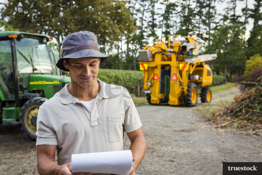 Farmer Using Clipboard on Farm