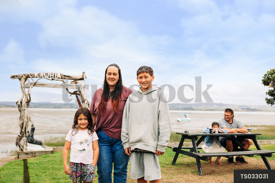 Family by picnic table at beach