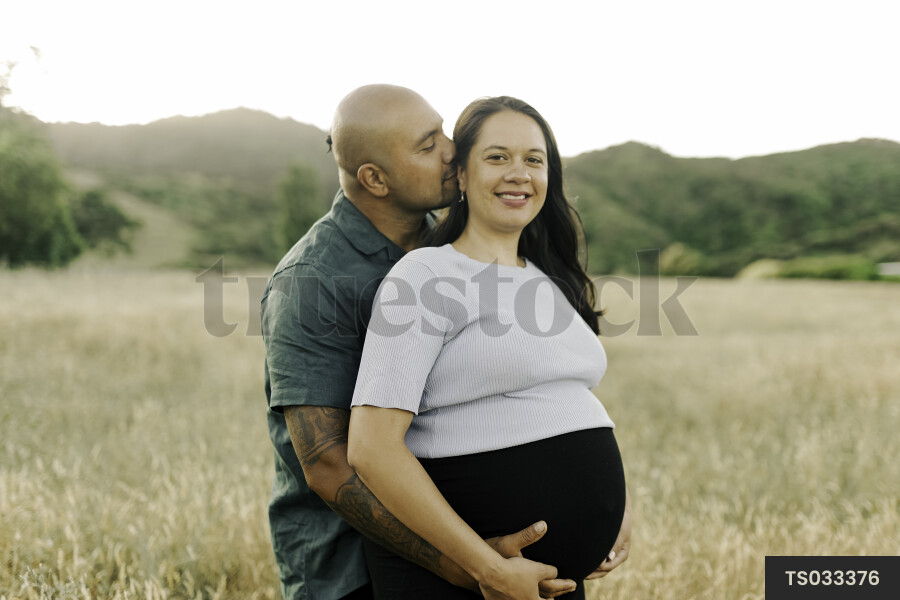 Husband and Pregnant Wife in Field