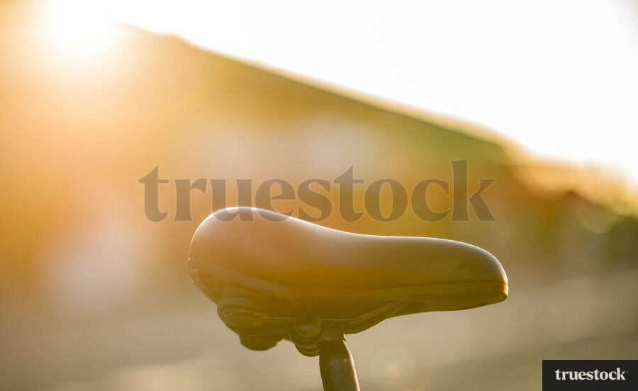 Close-up of a bike seat with soft light and unfocused background