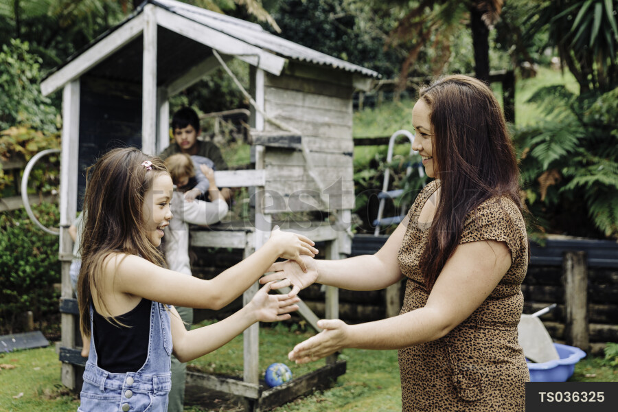 Mother and Daughter Doing a Handshake