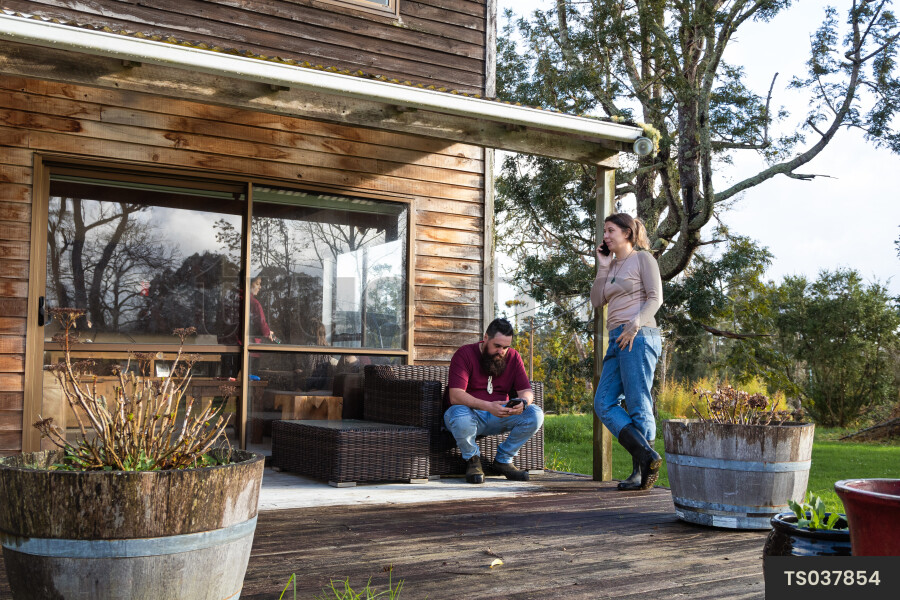 Family Using Phone on Deck