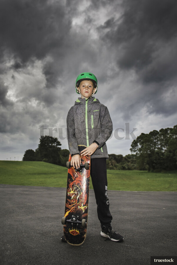Young Boy Holding Skateboard