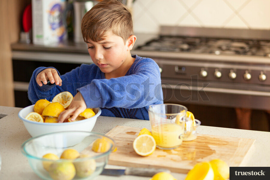 Young children making lemondade