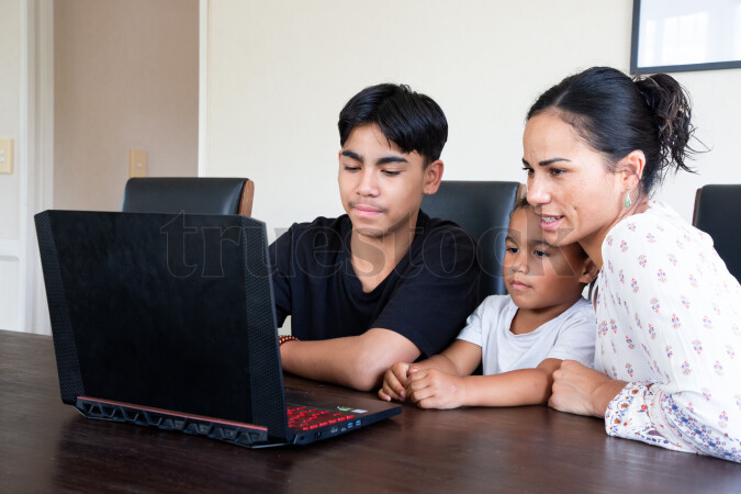Mother and Sons Using Laptop