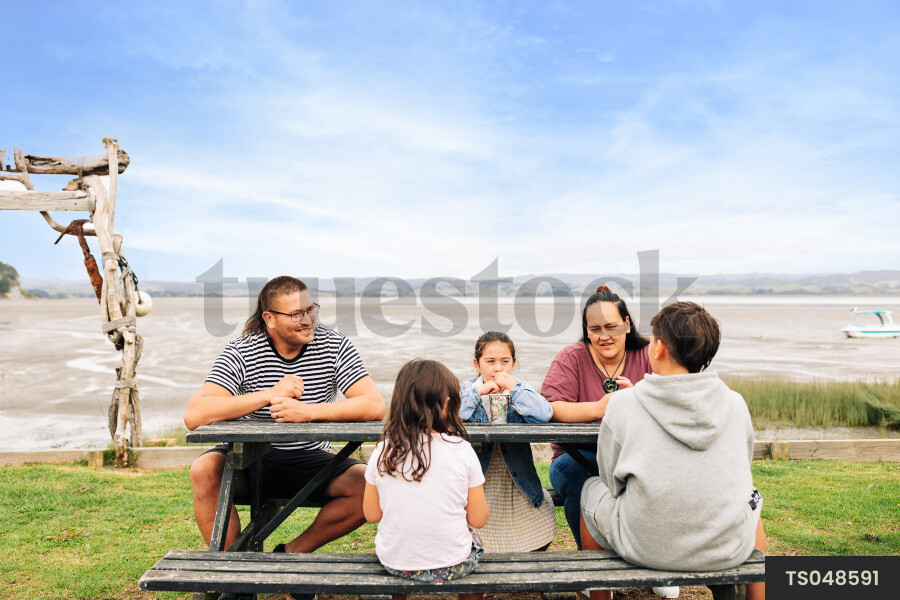Family sitting on picnic table