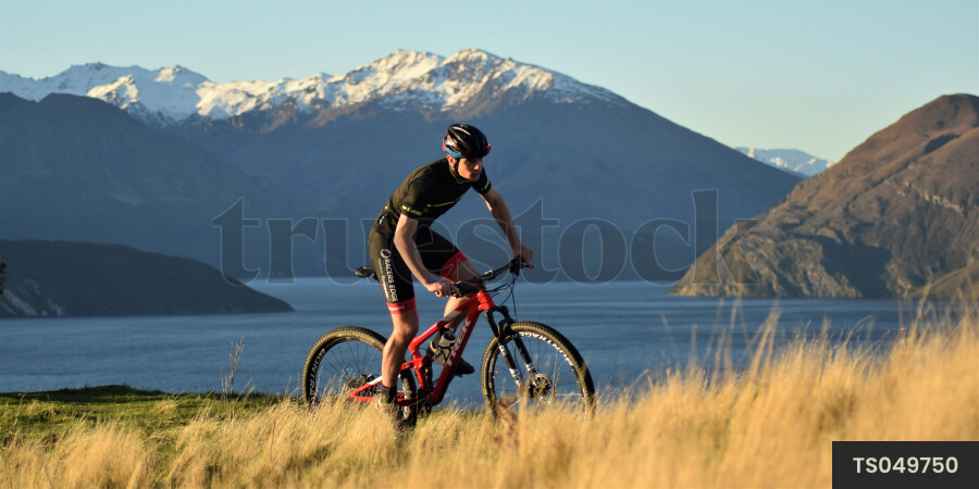 Man mountain biking by mountain