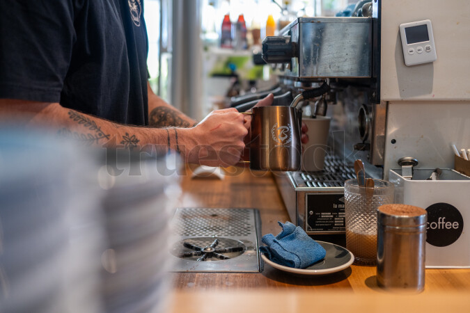 Man working at coffee machine in cafe