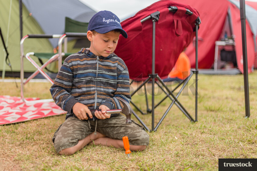 Child playing with tools at Kai Iwi lakes
