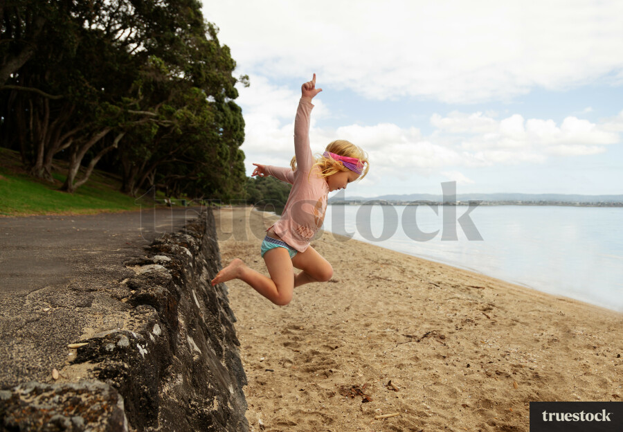 Girl Jumping onto the Sand