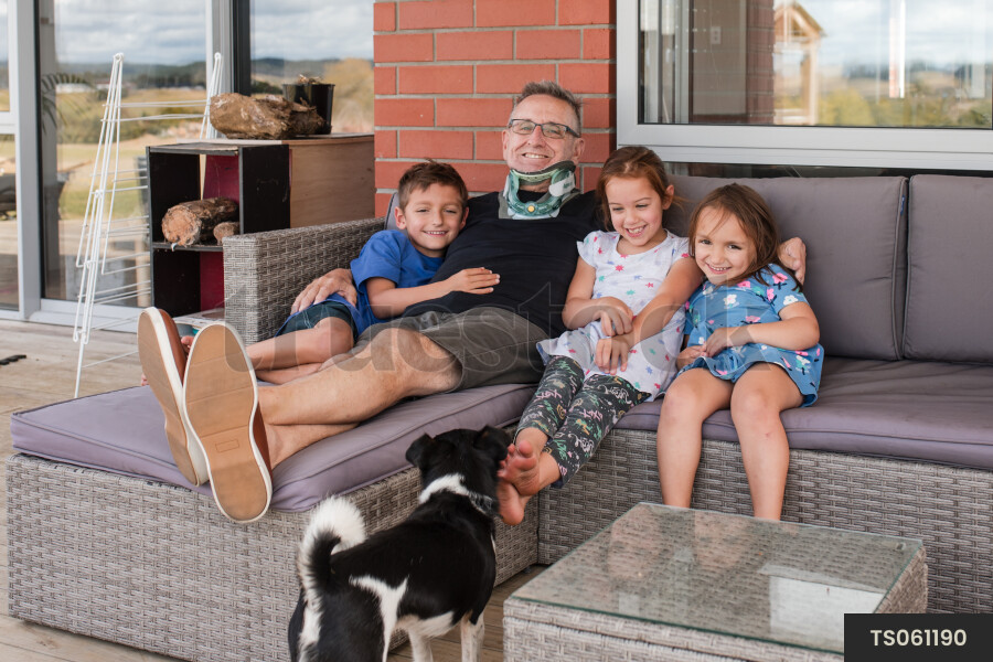 Man sitting with his grandchildren