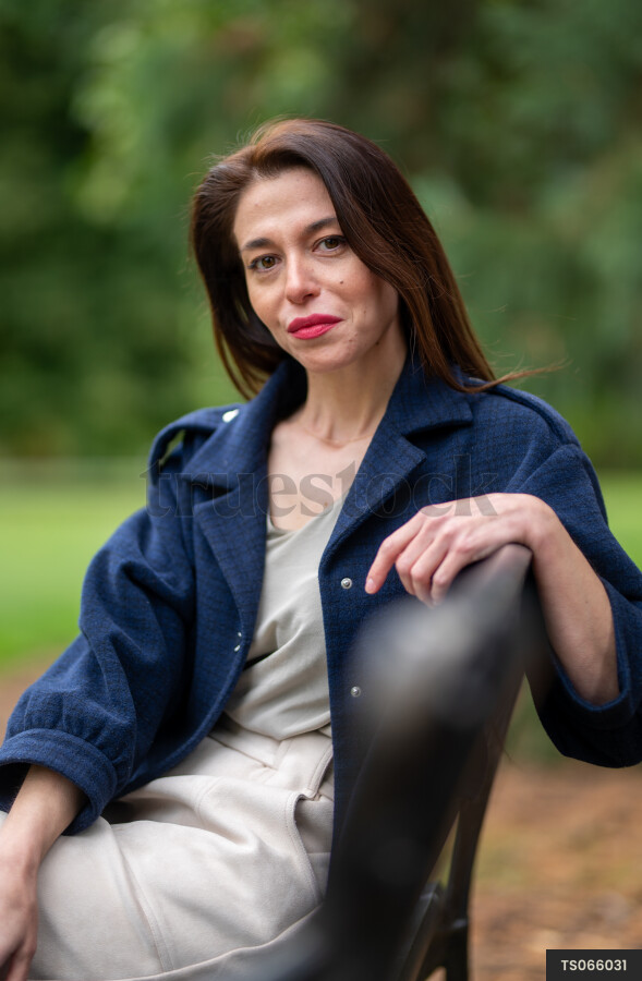 Woman sitting on park bench