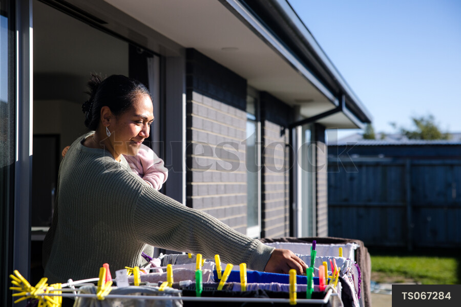 Woman doing laundry with her daughter