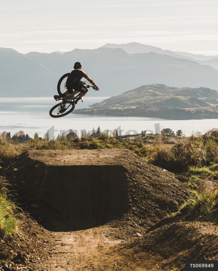 Man mountain biking on dirt trail