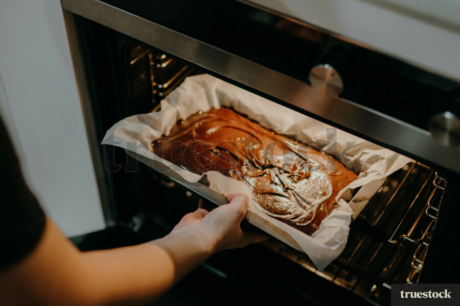 Placing brownies in the oven