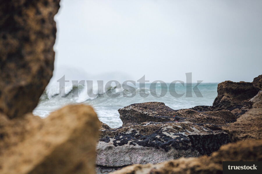 Huge waves crashing at the rocky coast with cliffs
