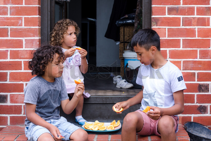 Kids Eating Oranges Outside