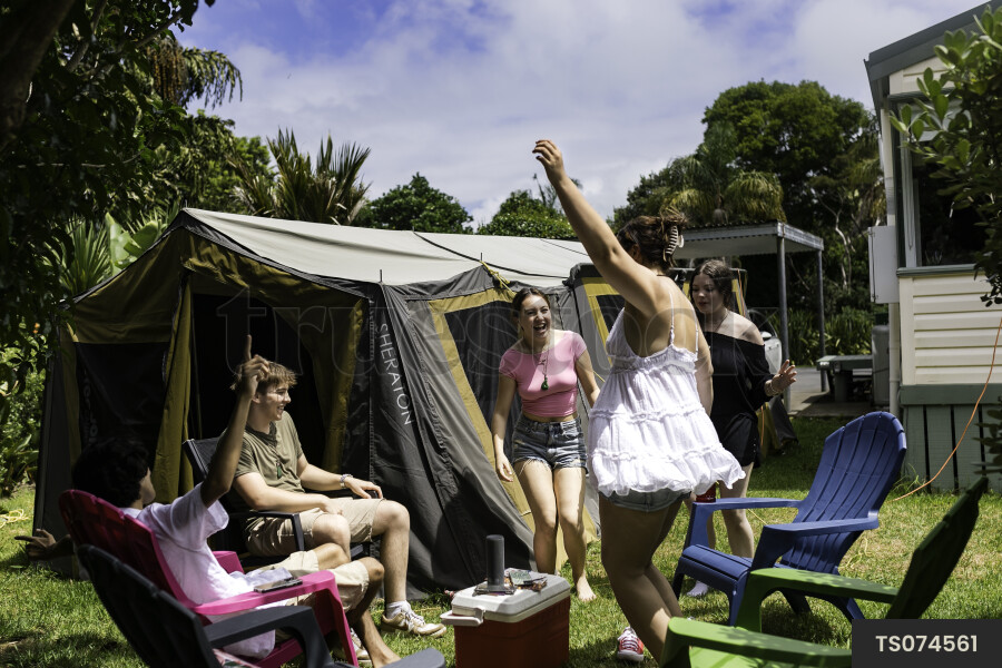 Friends sitting by tent