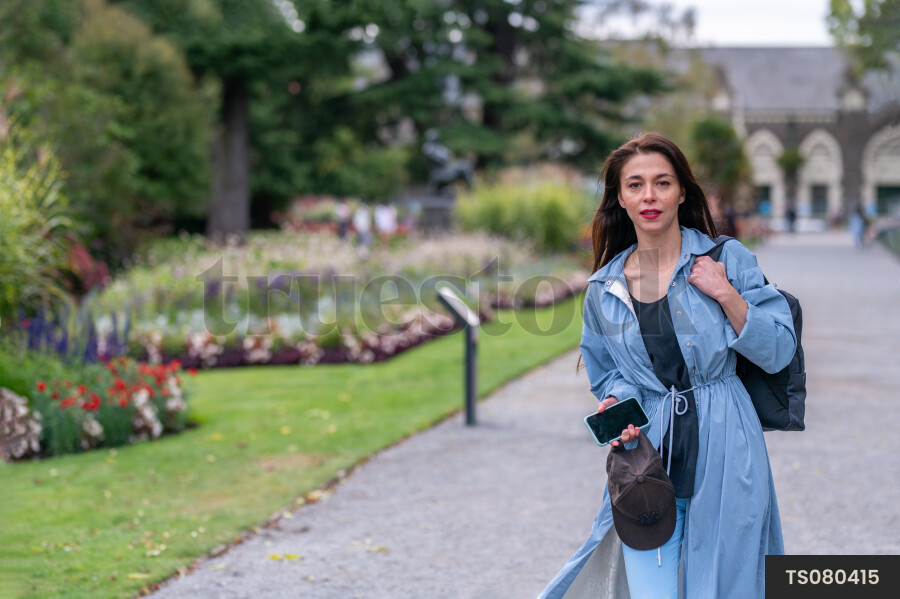 Woman with blue coat in park