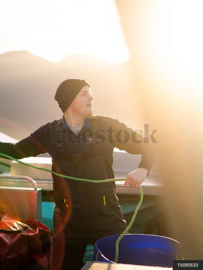 Man on boat at sunrise