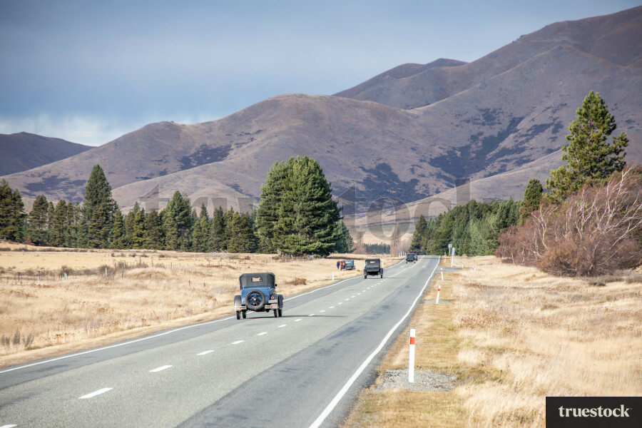 Vintage cars driving along Tekapo road