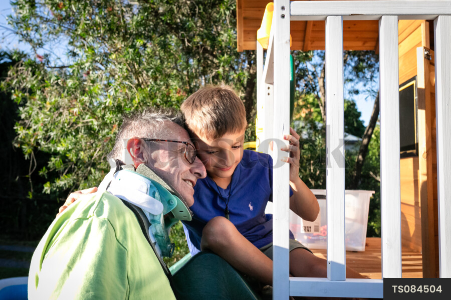 Man playing with grandson in playhouse