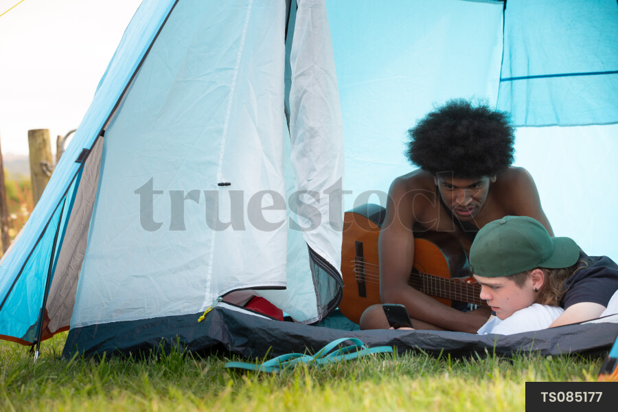Teens with Guitar in Tent