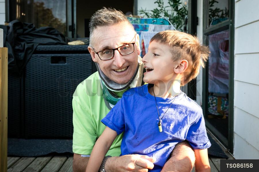Smiling man with his grandson