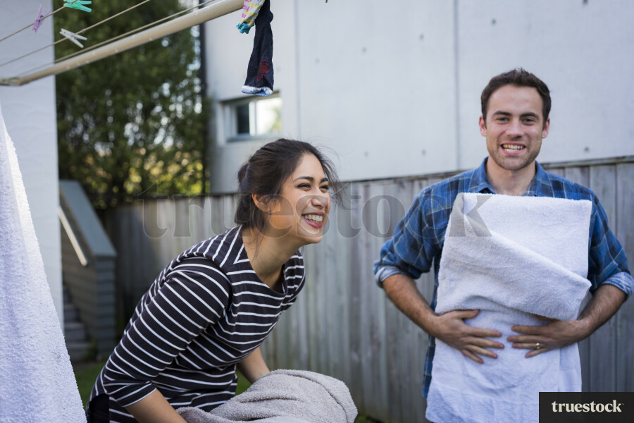 Young couple bring in the washing