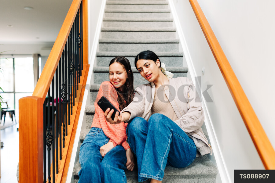 Friends taking selfie on staircase