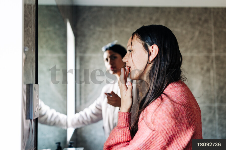 Friends getting ready in bathroom