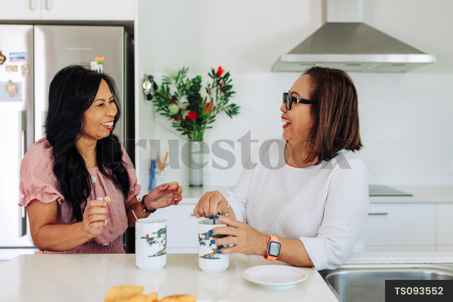 Women With Coffee in Kitchen