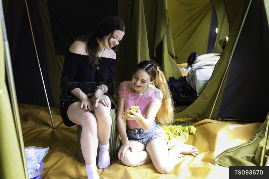 Friends sitting in tent