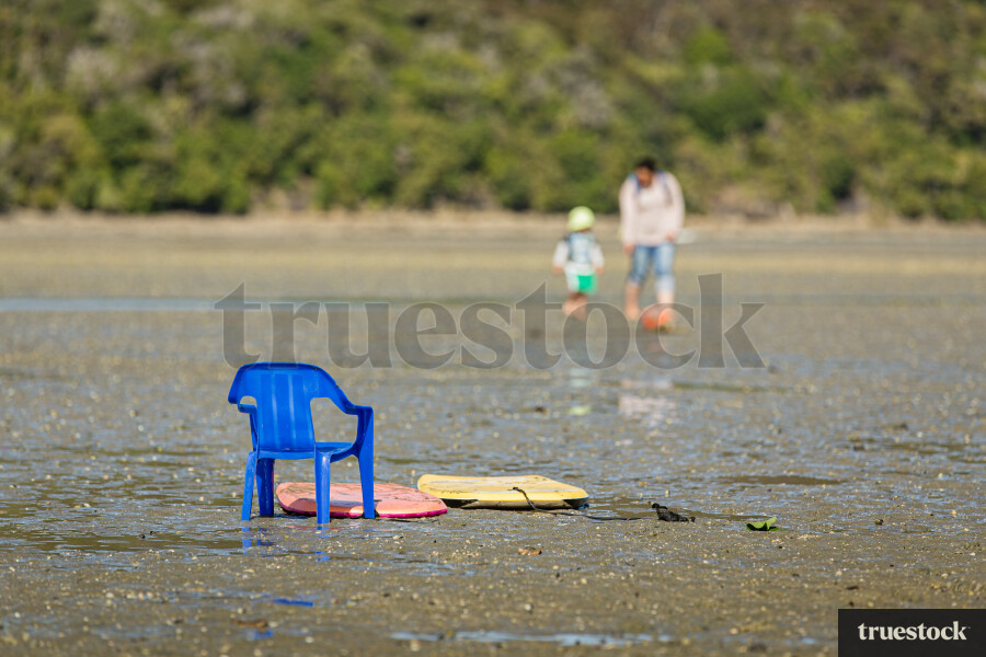 Chair and boogie boards at the beach