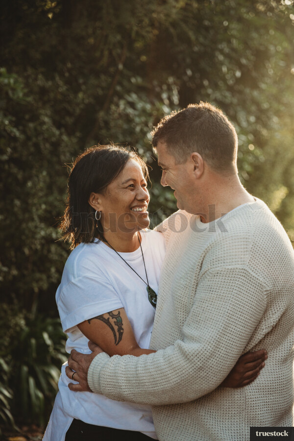 Portrait of happy married couple smiling looking into each other's eyes