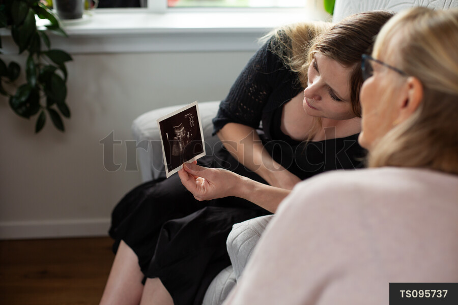 Nurse and pregnant woman looking at ultrasound