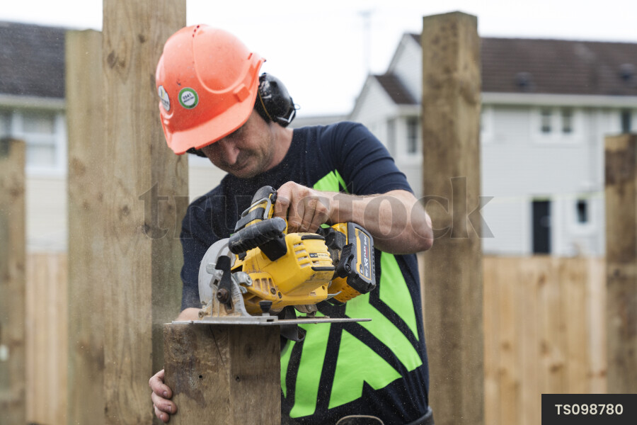 TS098780 Man working with power tools at construction site by Jeremy ...