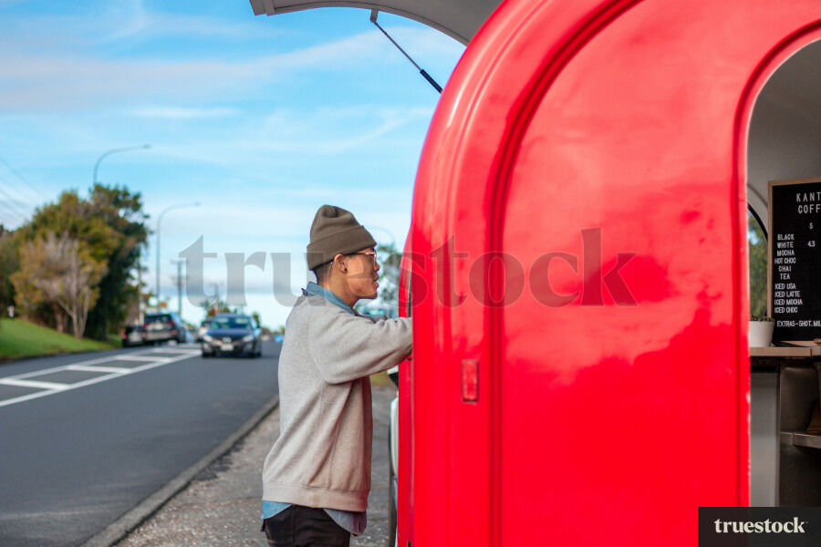 Customer using eftpos payment at roadside cafe coffee truck